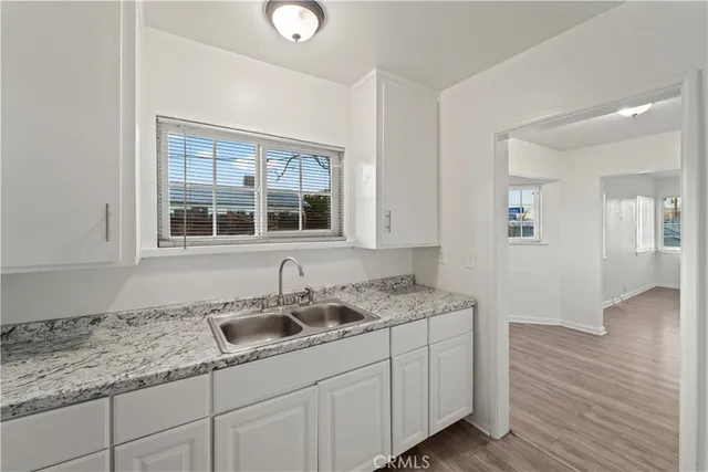 a kitchen with a sink stove and cabinets