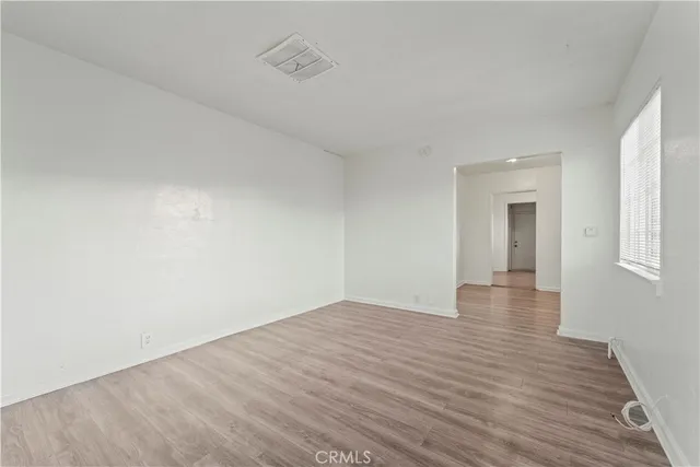 wooden floor in a hall with an empty room