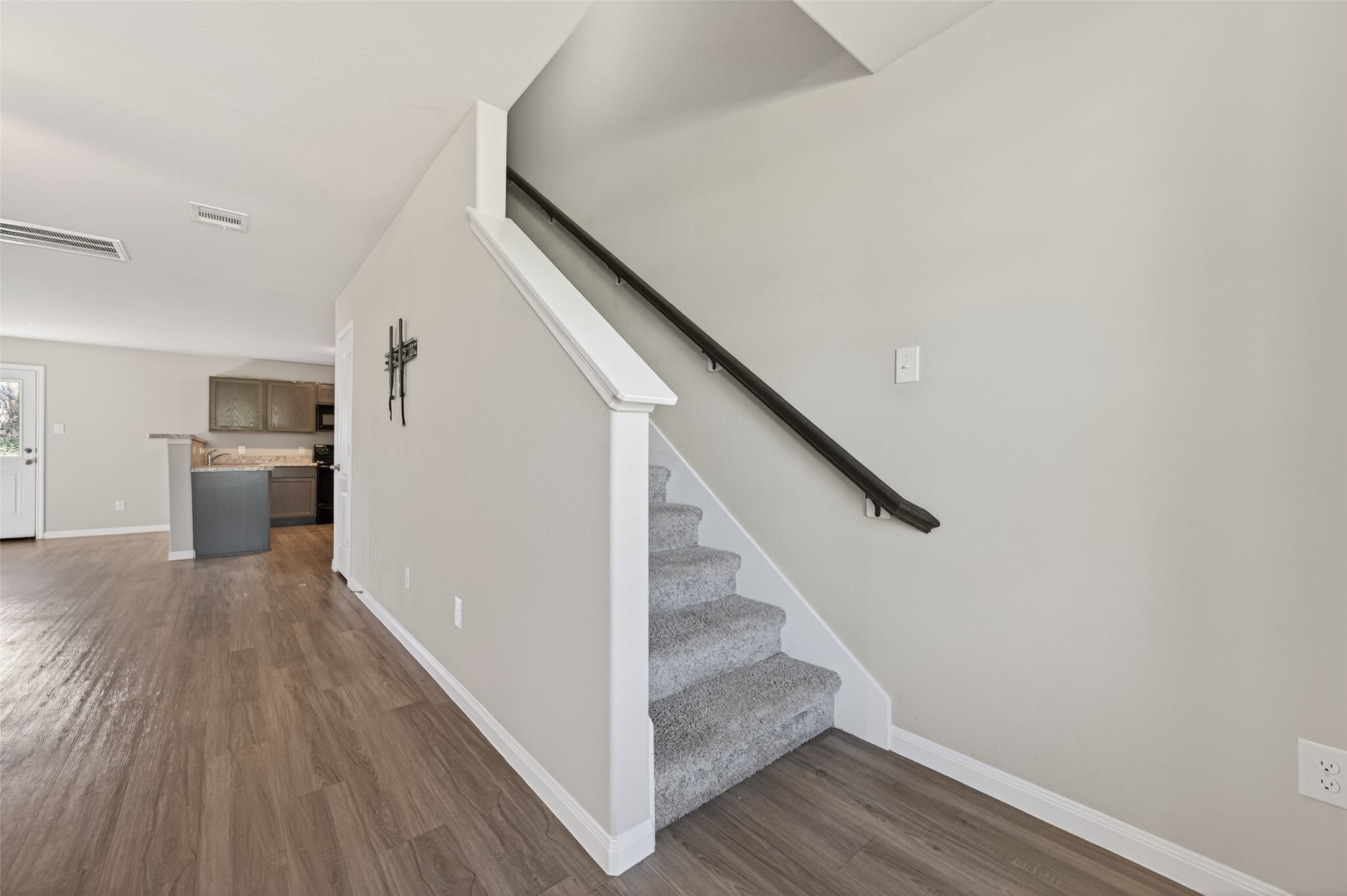 940 21st Street Hempstead, TX 77445 - Photo 13 of 32 a view of a hallway with wooden floor and staircase