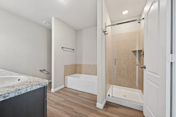 a bathroom with a bathtub and a shower