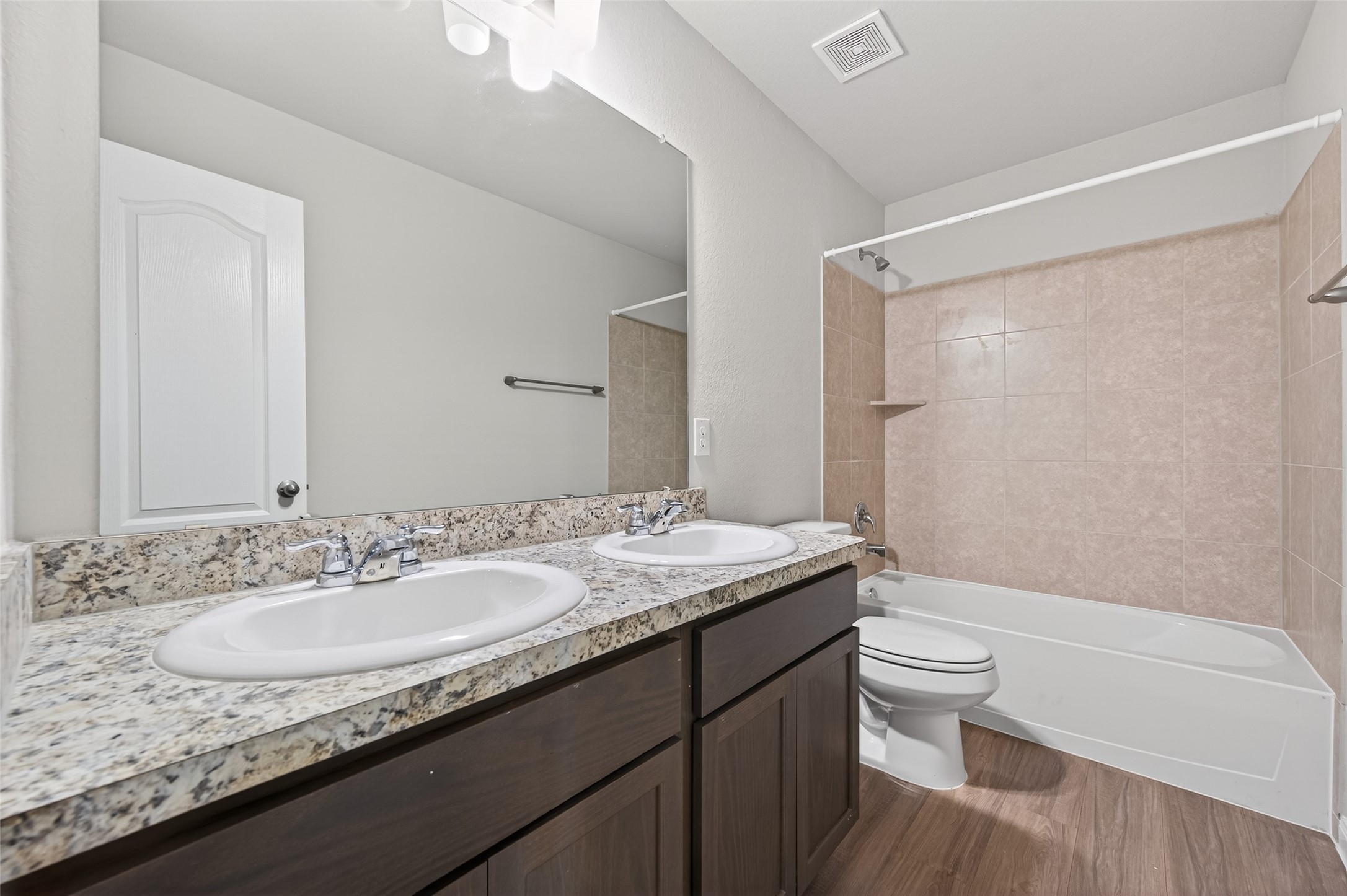 940 21st Street Hempstead, TX 77445 - Photo 24 of 32 a bathroom with a granite countertop sink a toilet a mirror and shower