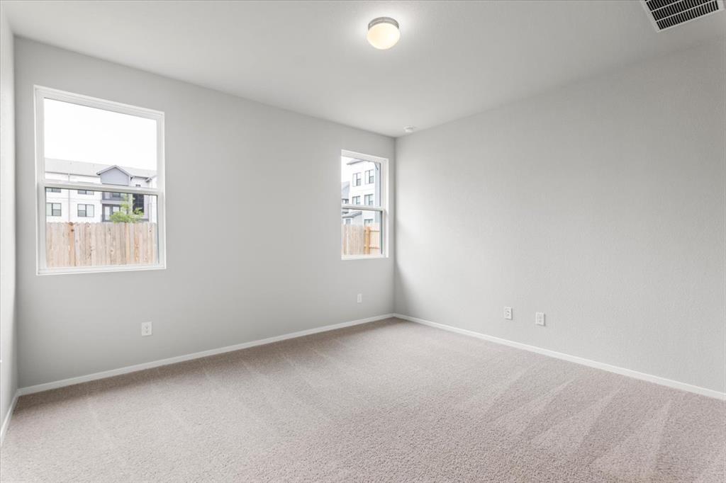 2707 Totley Road Manor, TX 78653 - Photo 17 of 39 Carpeted spare room featuring baseboards