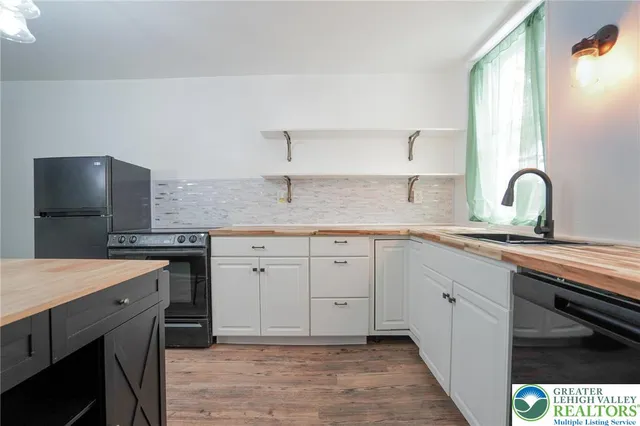 a kitchen with a sink and a stove top oven