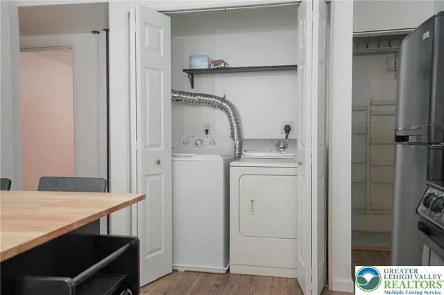 a view of entryway and hall with wooden floor