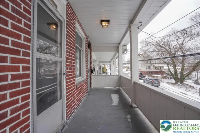 a view of a brick wall next to a window