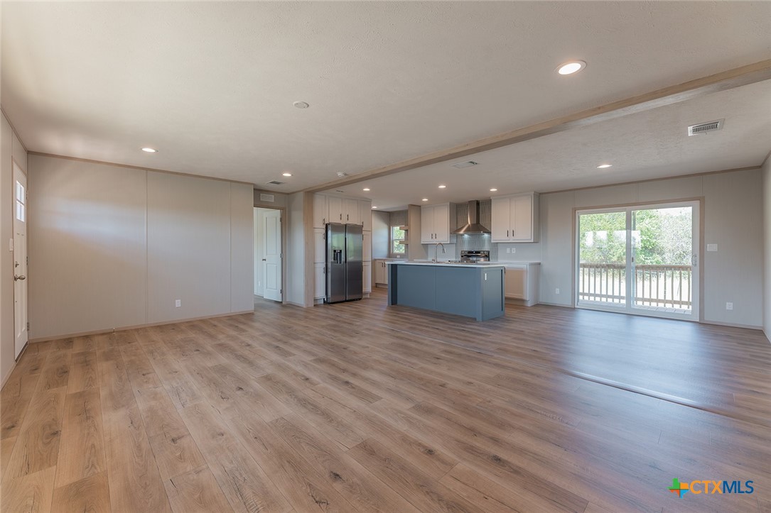 3505 Ivy Gap Road Kempner, TX 76539 - Photo 11 of 43 an empty room with wooden floor and windows