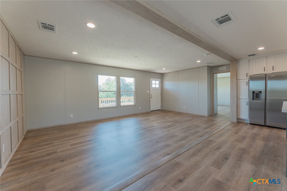 3505 Ivy Gap Road Kempner, TX 76539 - Photo 12 of 43 an empty room with wooden floor and windows