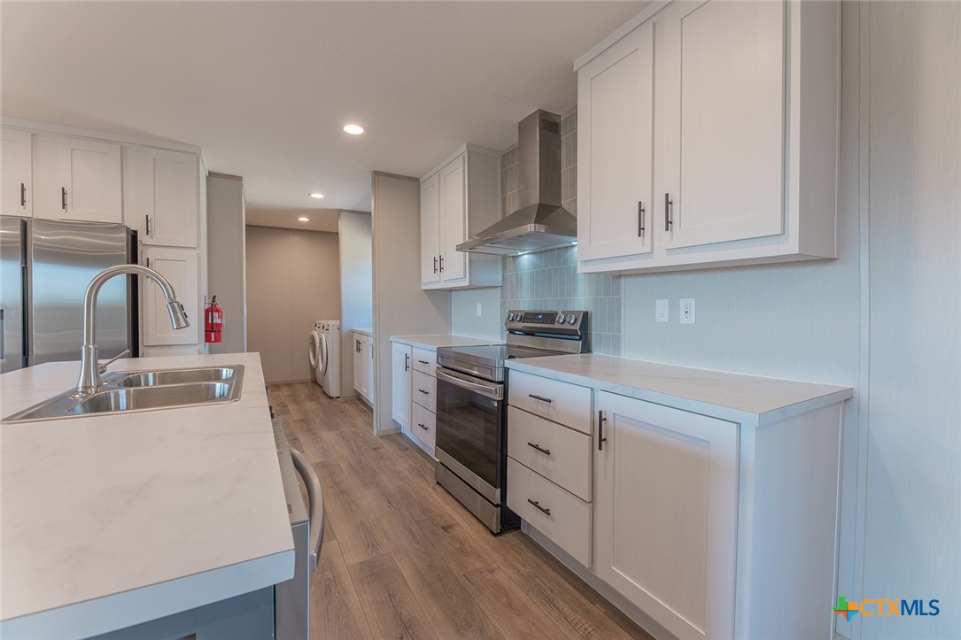 3505 Ivy Gap Road Kempner, TX 76539 - Photo 15 of 43 a kitchen with kitchen island granite countertop a sink cabinets and stainless steel appliances