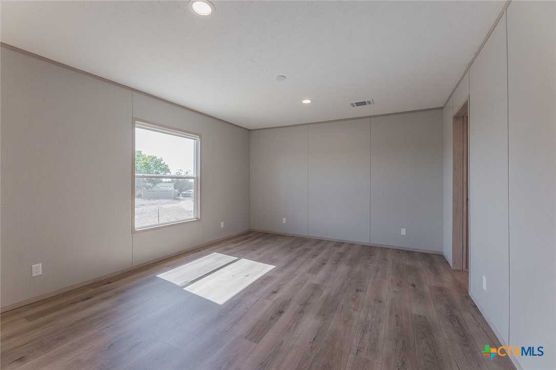 3505 Ivy Gap Road Kempner, TX 76539 - Photo 18 of 43 an empty room with wooden floor and windows