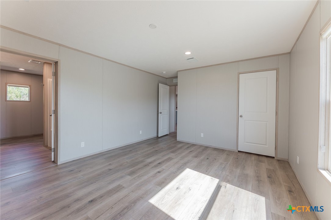 3505 Ivy Gap Road Kempner, TX 76539 - Photo 20 of 43 an empty room with wooden floor and windows