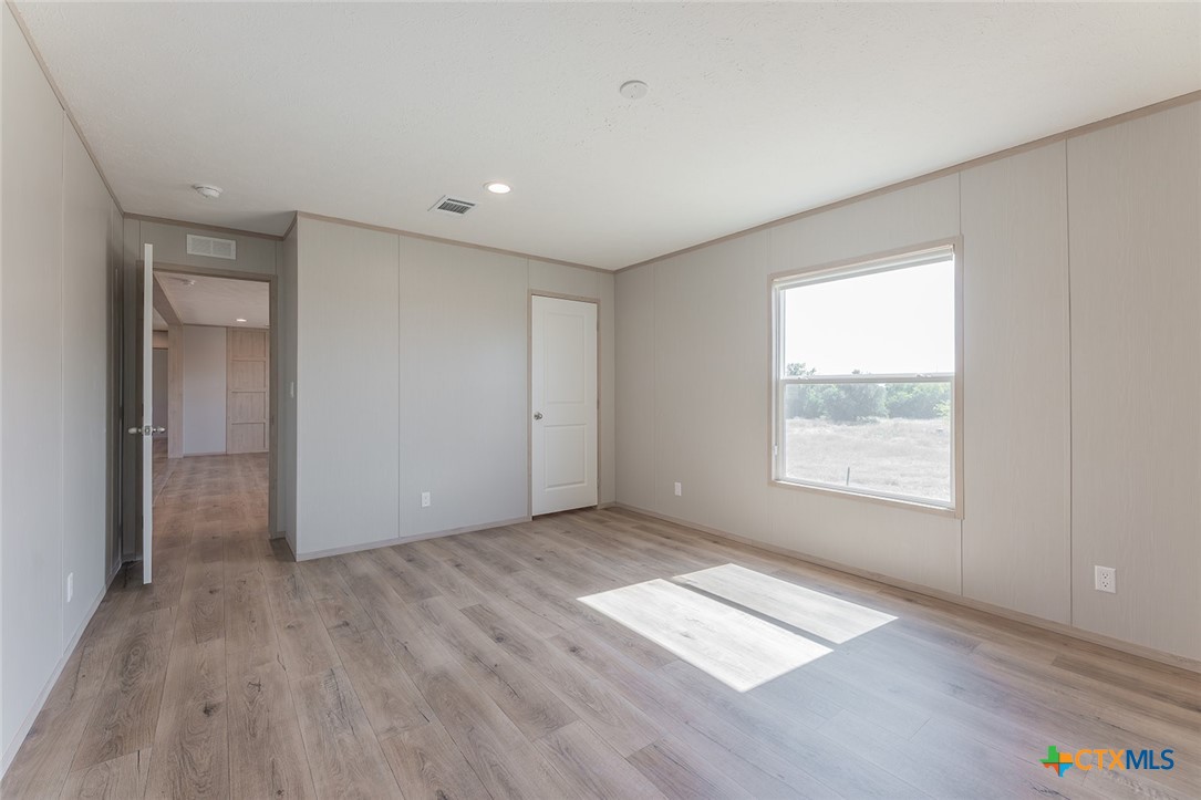 3505 Ivy Gap Road Kempner, TX 76539 - Photo 21 of 43 an empty room with wooden floor and windows