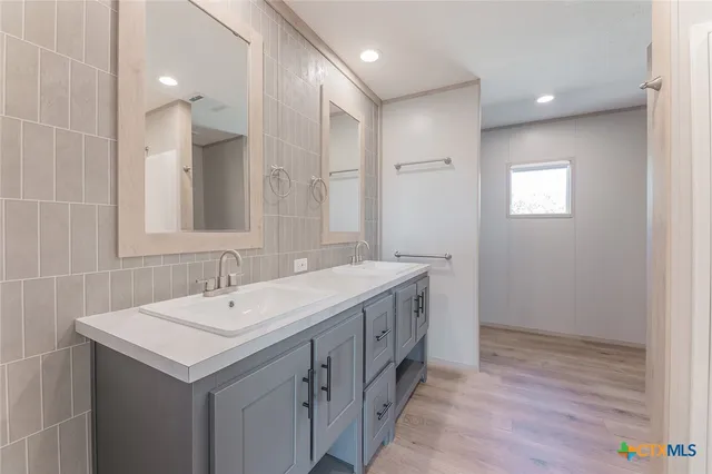 a bathroom with a sink a mirror and a bathtub