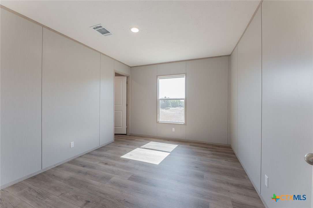 3505 Ivy Gap Road Kempner, TX 76539 - Photo 26 of 43 an empty room with wooden floor and windows