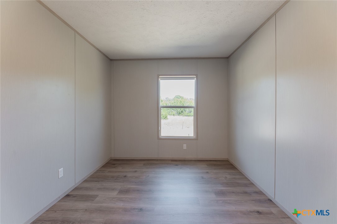 3505 Ivy Gap Road Kempner, TX 76539 - Photo 31 of 43 a view of an empty room with wooden floor and a window