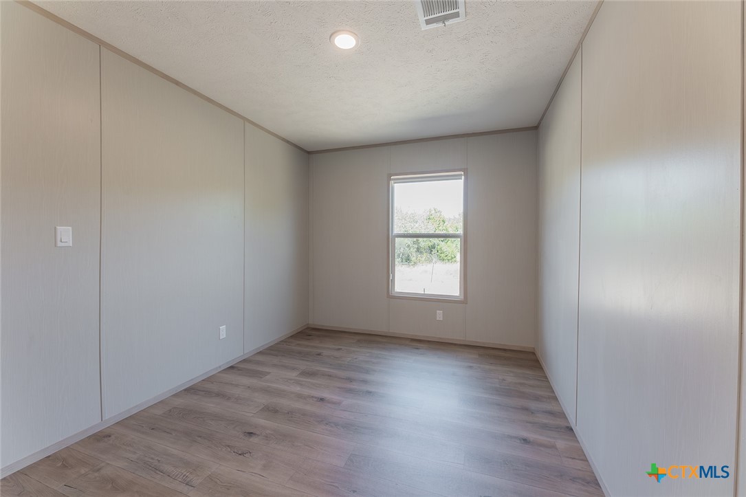 3505 Ivy Gap Road Kempner, TX 76539 - Photo 32 of 43 an empty room with wooden floor and window