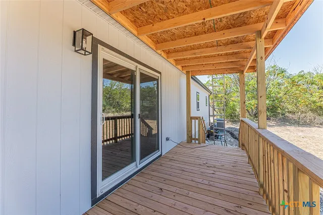 a view of balcony with wooden floor and fence