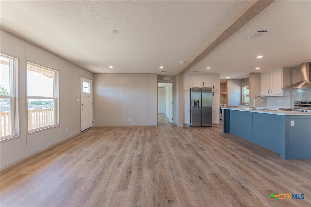 3505 Ivy Gap Road Kempner, TX 76539 - Photo 6 of 43 a view of an empty room with wooden floor and a window