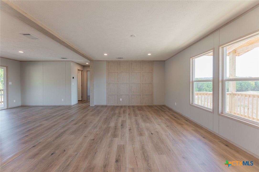3505 Ivy Gap Road Kempner, TX 76539 - Photo 7 of 43 an empty room with wooden floor and windows