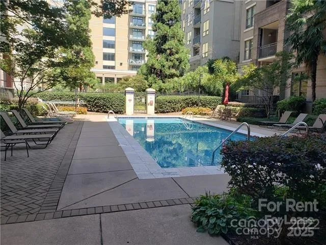 a view of swimming pool with outdoor seating and plants