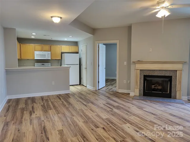 a view of a room wooden floor and a kitchen