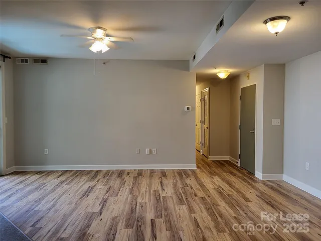 a view of room with wooden floor