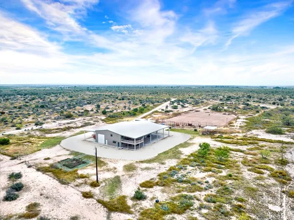 a large kitchen with a table and chairs in it