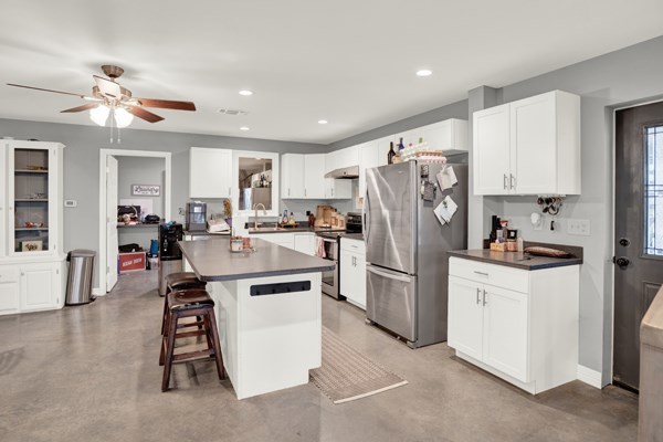 16033 Door Key Road San Angelo, TX 76904 - Photo 26 of 100 a kitchen that has a lot of white cabinets and stainless steel appliances