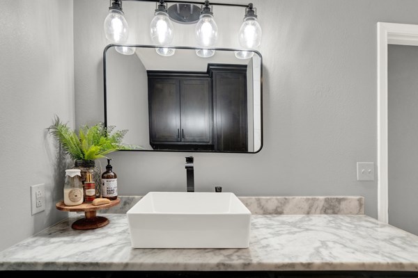 16033 Door Key Road San Angelo, TX 76904 - Photo 33 of 100 a bathroom with a sink and a mirror