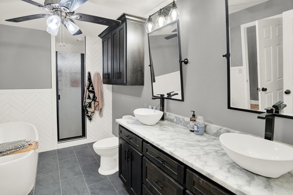 16033 Door Key Road San Angelo, TX 76904 - Photo 36 of 100 a bathroom with a granite countertop sink a toilet a mirror and shower