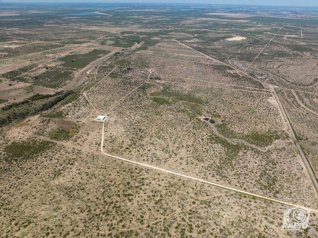 16033 Door Key Road San Angelo, TX 76904 - Photo 92 of 100 a view of a dry yard with wooden floor
