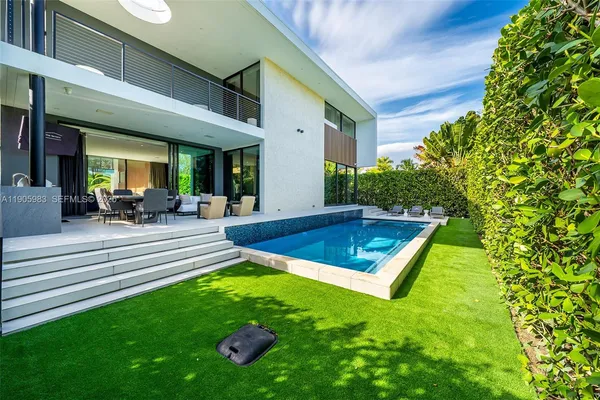 a living room with furniture and a book shelf