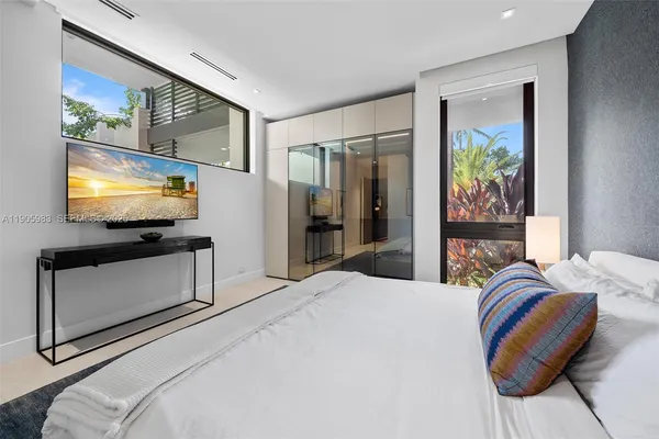 a bedroom with a bed and a painting on the wall