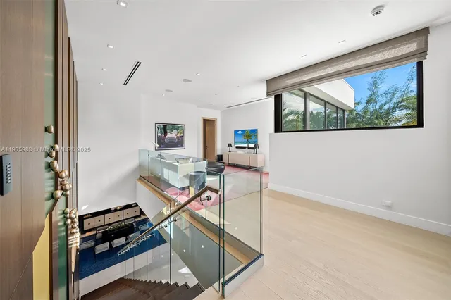 a bedroom with a bed painting on wall and a potted plant