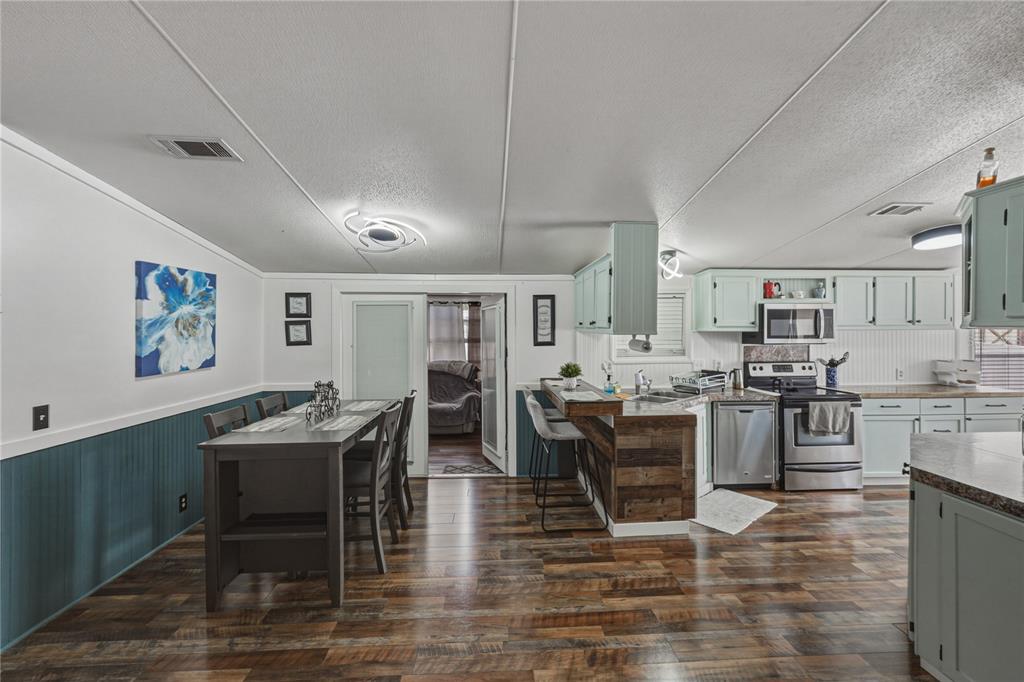4695 Turner Road Mulberry, FL 33860 - Photo 14 of 51 a living room with stainless steel appliances kitchen island granite countertop furniture and a dining table