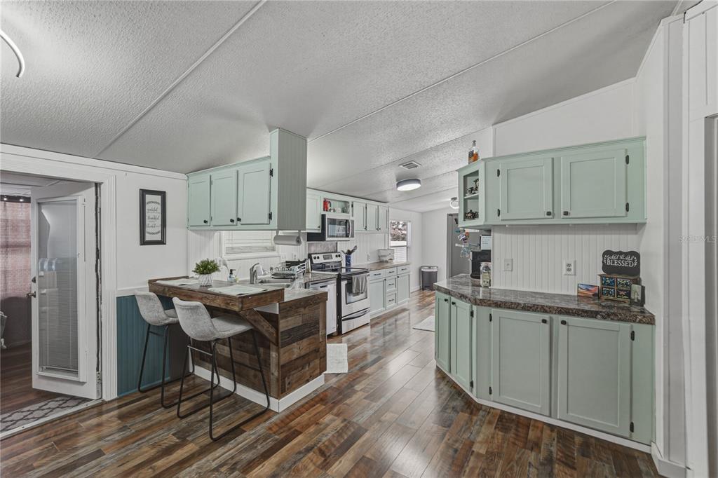 4695 Turner Road Mulberry, FL 33860 - Photo 15 of 51 a kitchen with stainless steel appliances granite countertop a stove refrigerator and cabinets