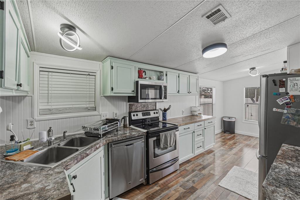 4695 Turner Road Mulberry, FL 33860 - Photo 16 of 51 a kitchen with stainless steel appliances granite countertop a sink stove and refrigerator