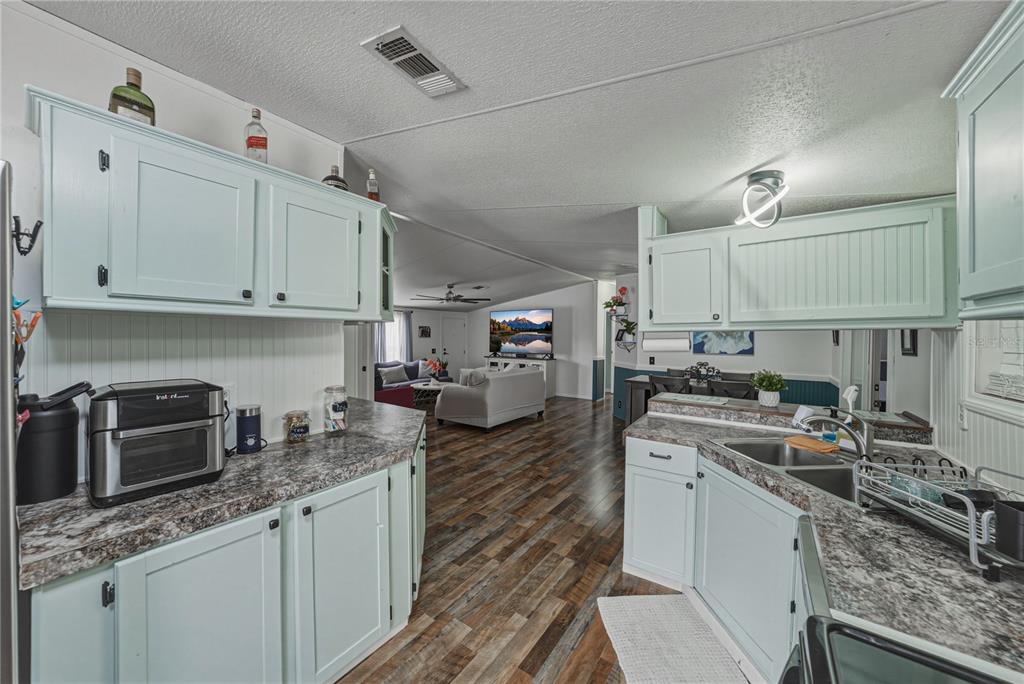4695 Turner Road Mulberry, FL 33860 - Photo 18 of 51 a kitchen with kitchen island granite countertop a sink stainless steel appliances and white cabinets