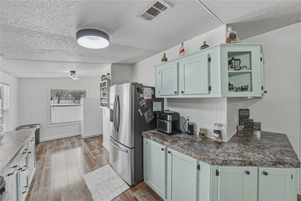 4695 Turner Road Mulberry, FL 33860 - Photo 19 of 51 a kitchen with refrigerator and cabinets