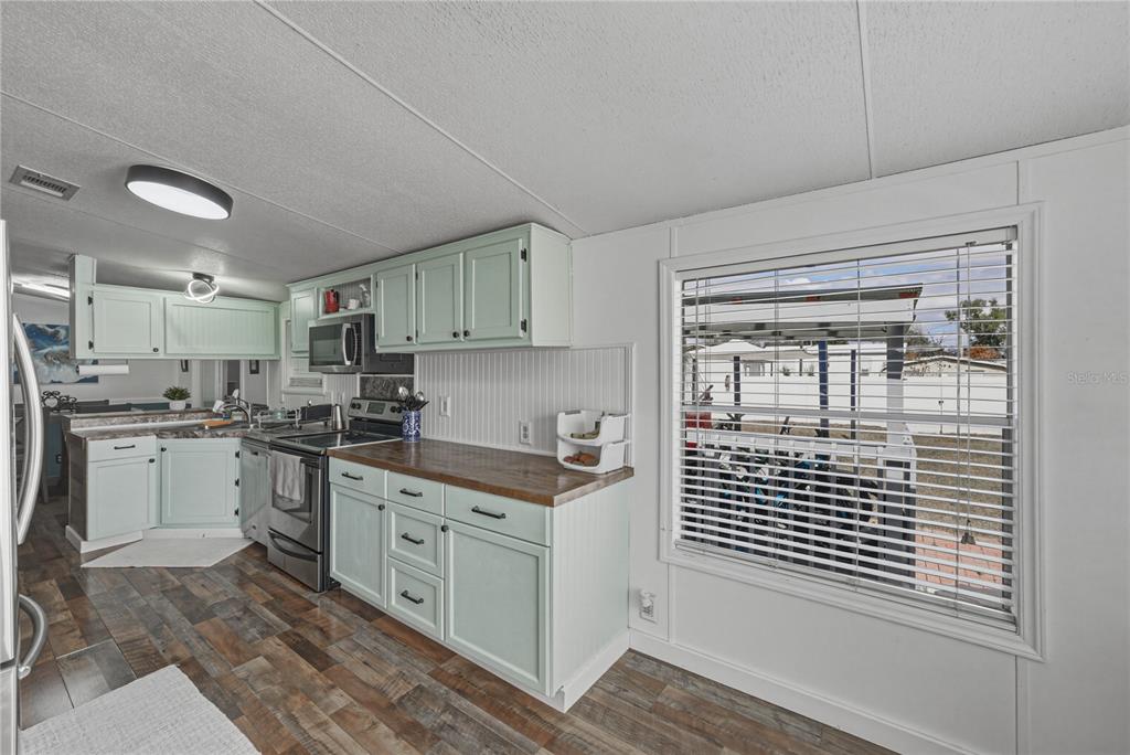 4695 Turner Road Mulberry, FL 33860 - Photo 20 of 51 a kitchen with a sink a stove and cabinets