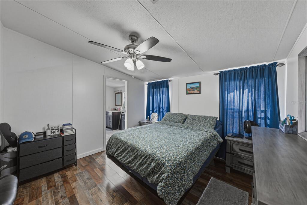 4695 Turner Road Mulberry, FL 33860 - Photo 26 of 51 a spacious bedroom with a bed and a chandelier