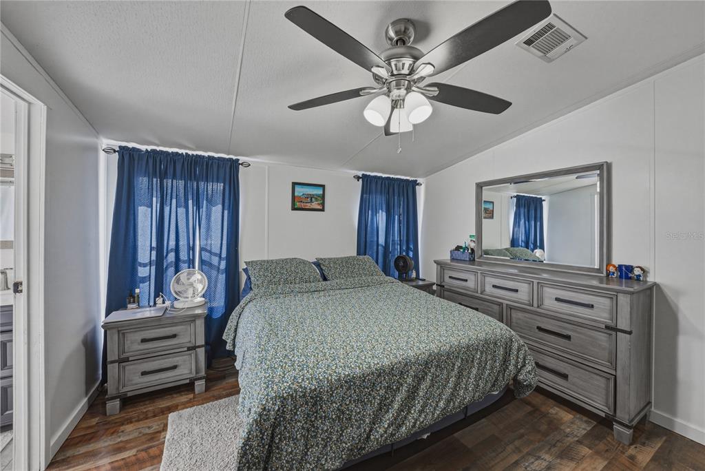 4695 Turner Road Mulberry, FL 33860 - Photo 28 of 51 a bedroom with a bed and wooden floor