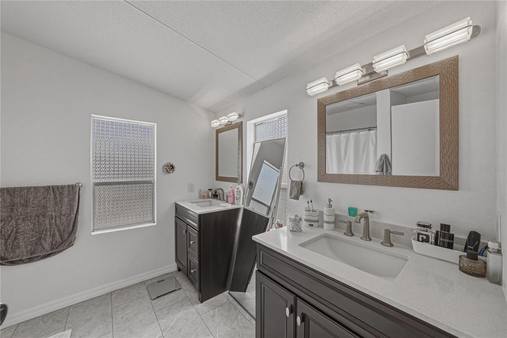 4695 Turner Road Mulberry, FL 33860 - Photo 29 of 51 a bathroom with a sink double vanity and a mirror