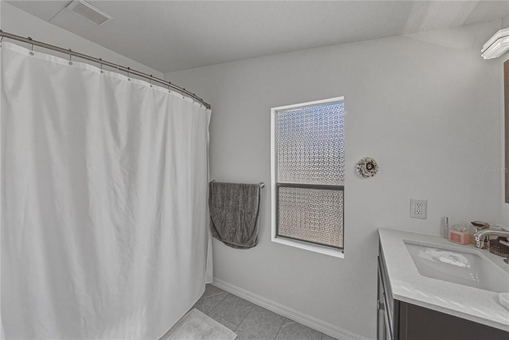 4695 Turner Road Mulberry, FL 33860 - Photo 31 of 51 a bathroom with a sink and a shower curtain