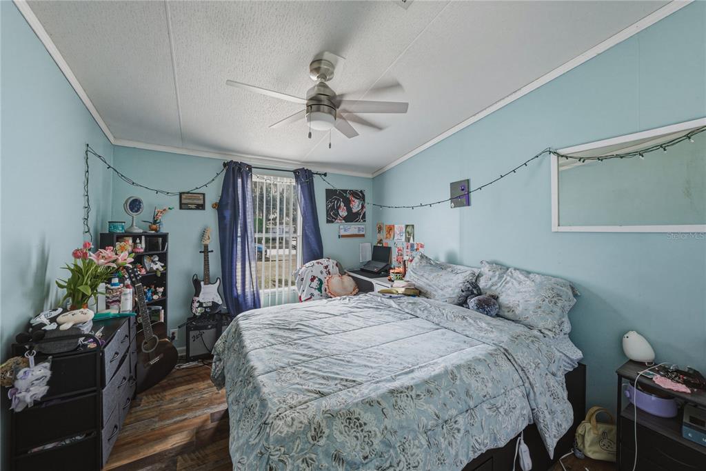 4695 Turner Road Mulberry, FL 33860 - Photo 33 of 51 a bedroom with a bed a dresser and potted plants