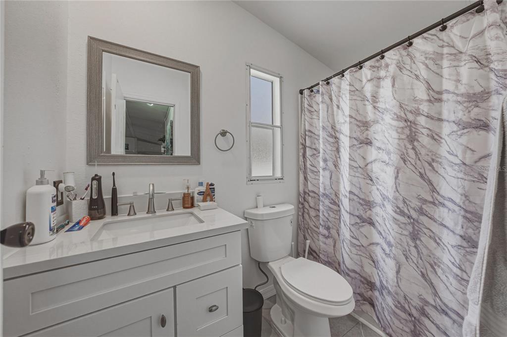 4695 Turner Road Mulberry, FL 33860 - Photo 36 of 51 a bathroom with a sink a toilet and a mirror