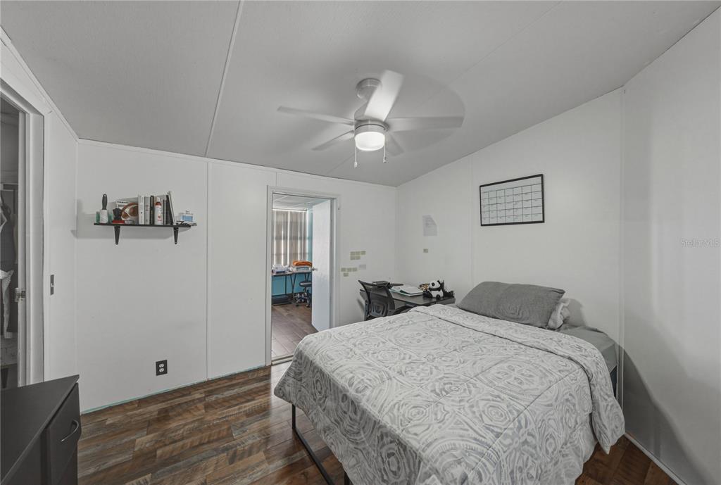 4695 Turner Road Mulberry, FL 33860 - Photo 37 of 51 a bedroom with a bed and a chandelier