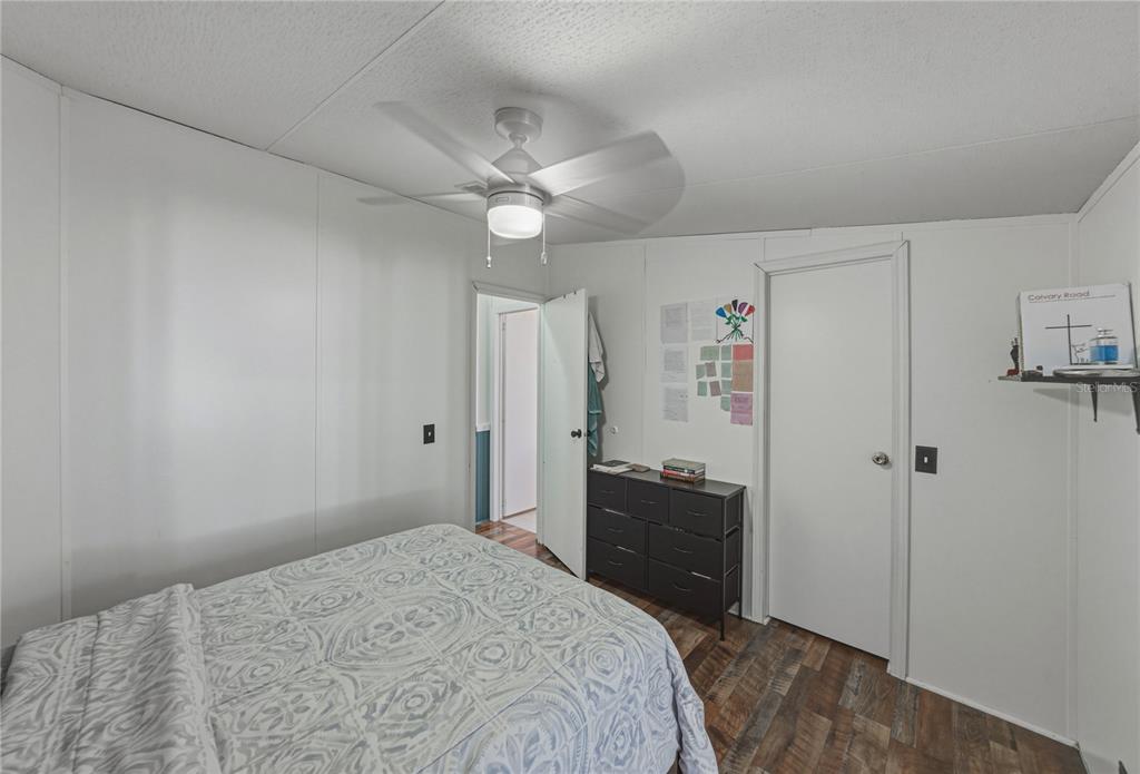 4695 Turner Road Mulberry, FL 33860 - Photo 38 of 51 a bedroom with a bed and a chandelier