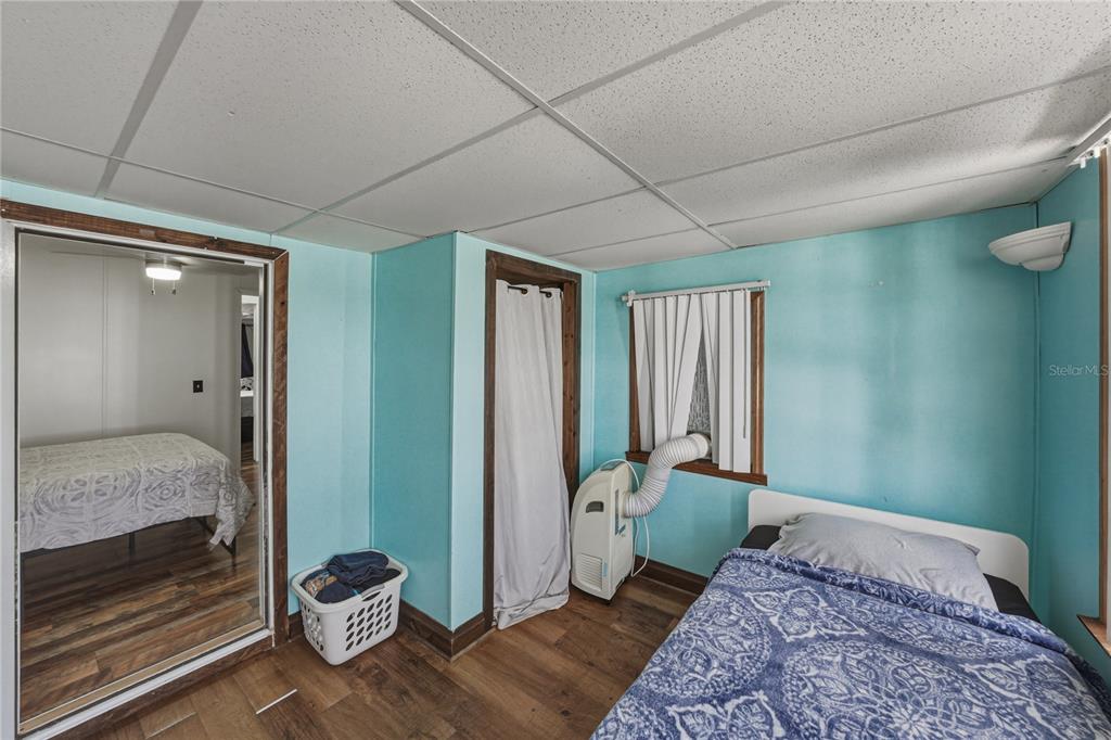 4695 Turner Road Mulberry, FL 33860 - Photo 40 of 51 a bedroom with a bed and wooden floor