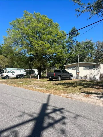 a view of a swimming pool with a house in the background