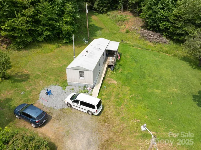 a bed sitting in a yard next to a yard